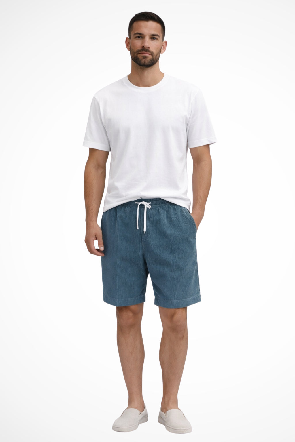 Model in relaxed shorts, seated casual pose
