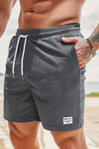 Model walking in relaxed drawstring shorts