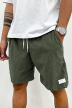 Model wearing relaxed corduroy shorts, standing pose