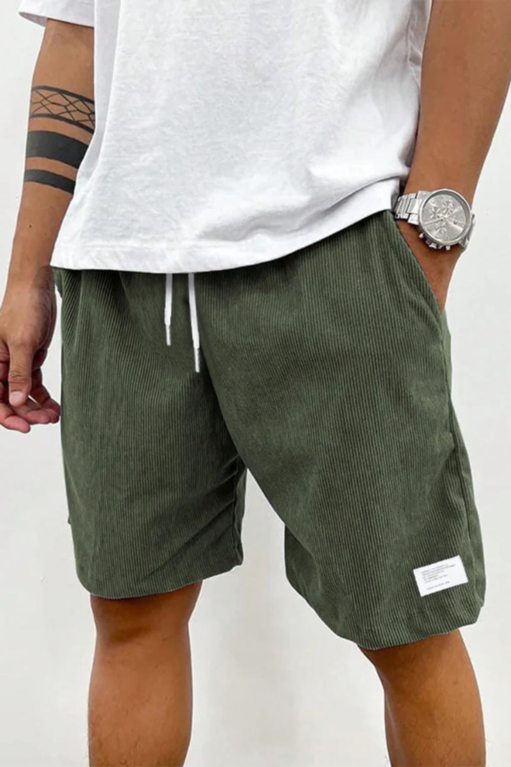 Model wearing relaxed corduroy shorts, standing pose