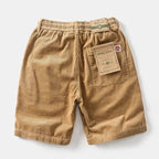 Model wearing corduroy shorts, standing pose