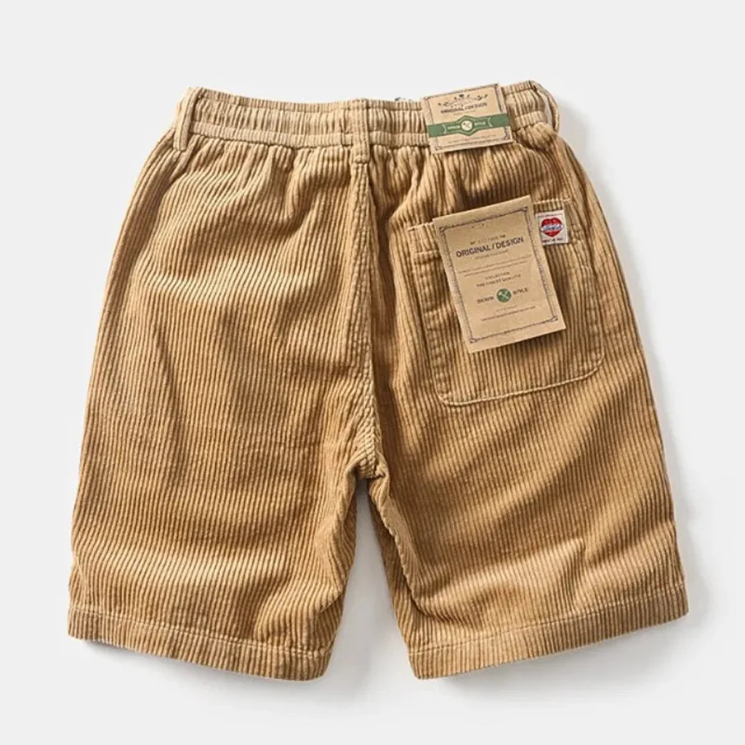 Model wearing corduroy shorts, standing pose