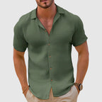 Model wearing shirt unbuttoned over plain tee