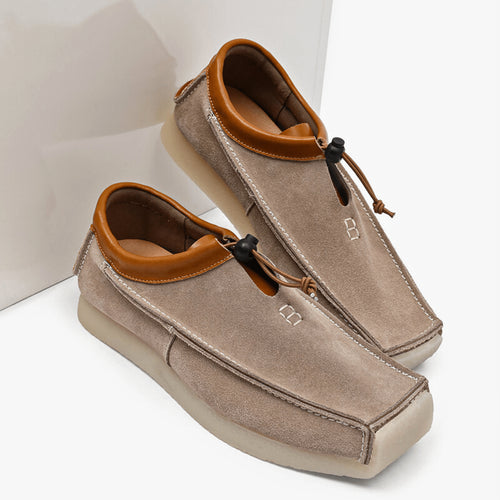 Loafers worn on feet, side profile showing square toe shape