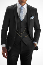 Model wearing suit jacket and waistcoat, standing pose