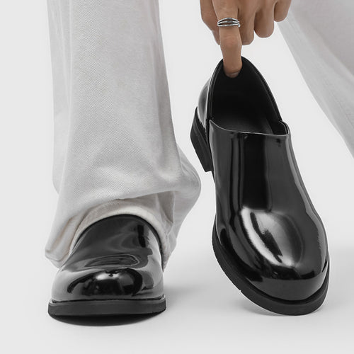 Black patent leather loafer with low block heel, front three-quarter view