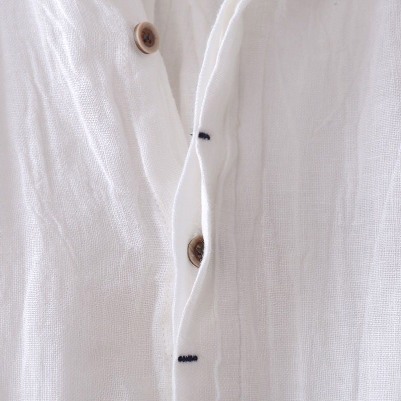 Flat lay of folded crinkle linen shirt showing full garment