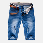 Model wearing blue distressed shorts, side angle showing relaxed fit