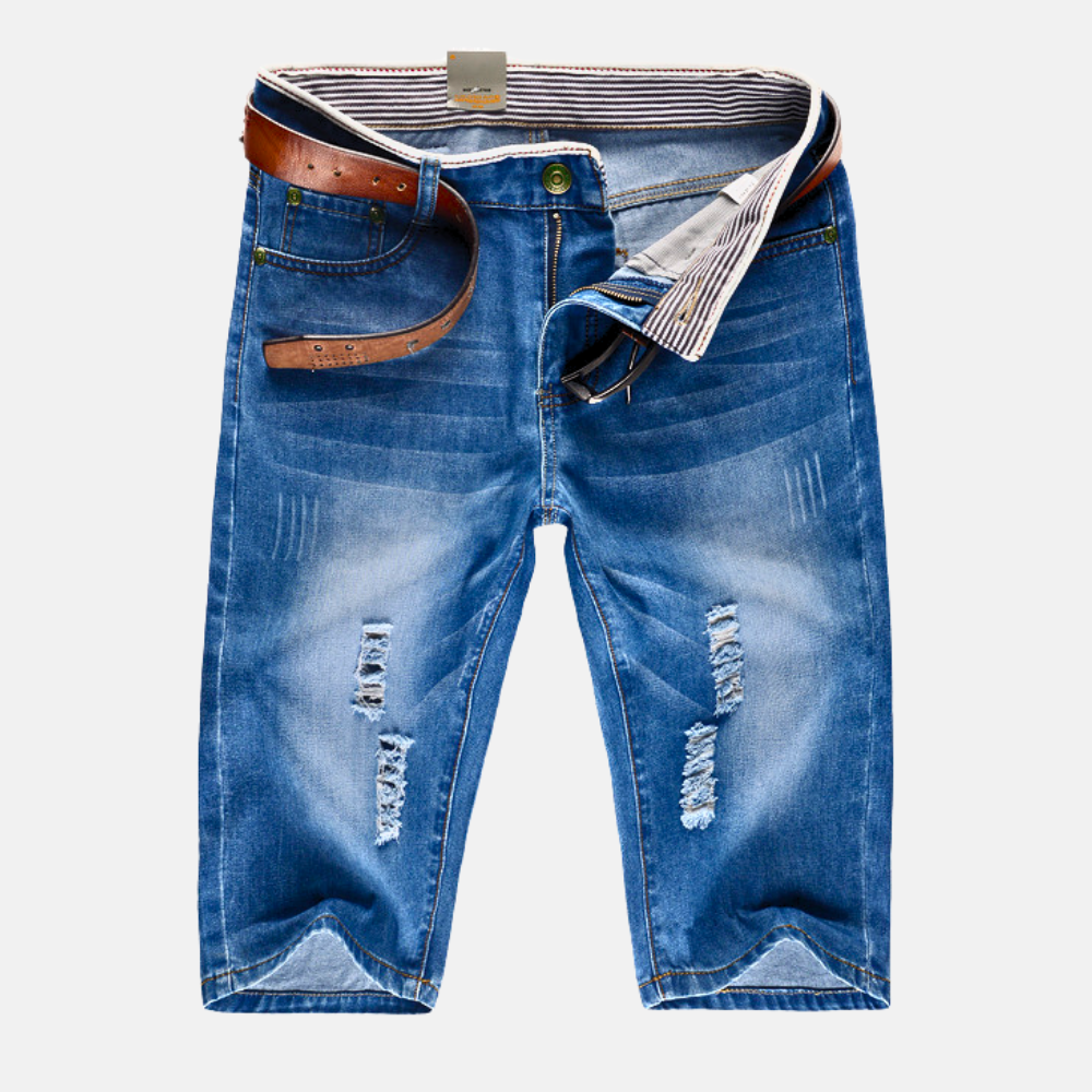 Model wearing blue distressed shorts, side angle showing relaxed fit