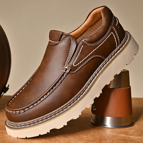 Pair of brown leather slip-on loafers shown from the side
