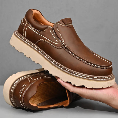 Man wearing leather loafers while sitting, showing side profile