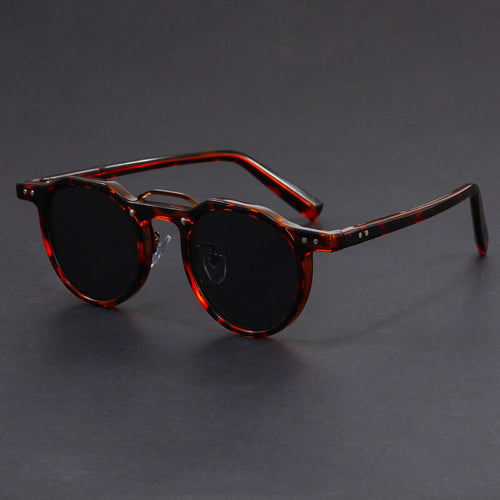 Model wearing tortoise round frame sunglasses, side profile shot