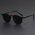 Man wearing round tortoise sunglasses in casual outdoor setting