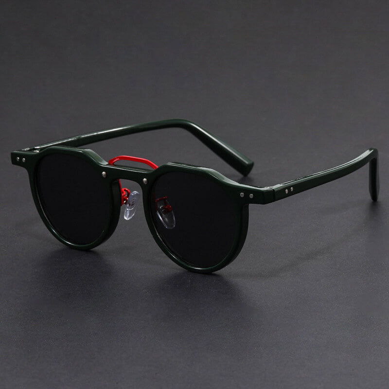 Man wearing round tortoise sunglasses in casual outdoor setting