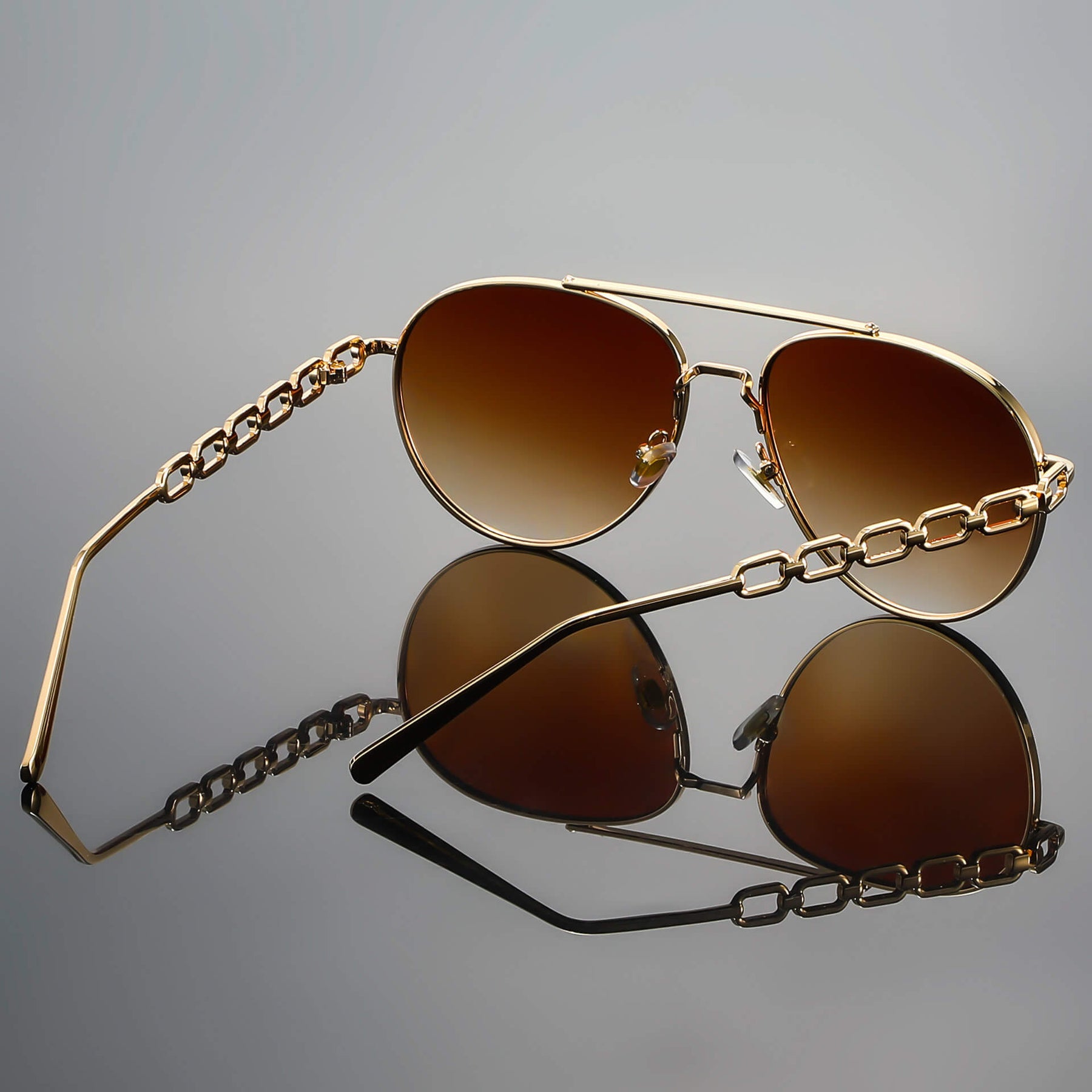Model in casual outfit wearing chain link aviator sunglasses, overhead angle
