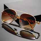 Flat lay of chain link aviator sunglasses showing full frame design
