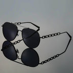 Detail shot of gradient brown lens and polished gold-tone frame