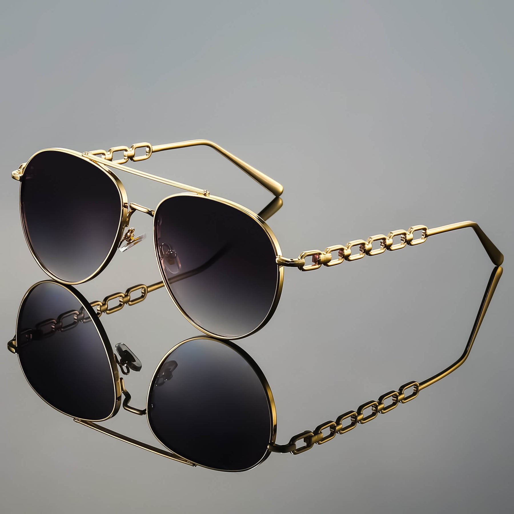 Chain link aviator sunglasses worn by model, three-quarter angle