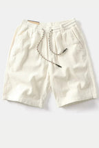 Model seated wearing corduroy shorts