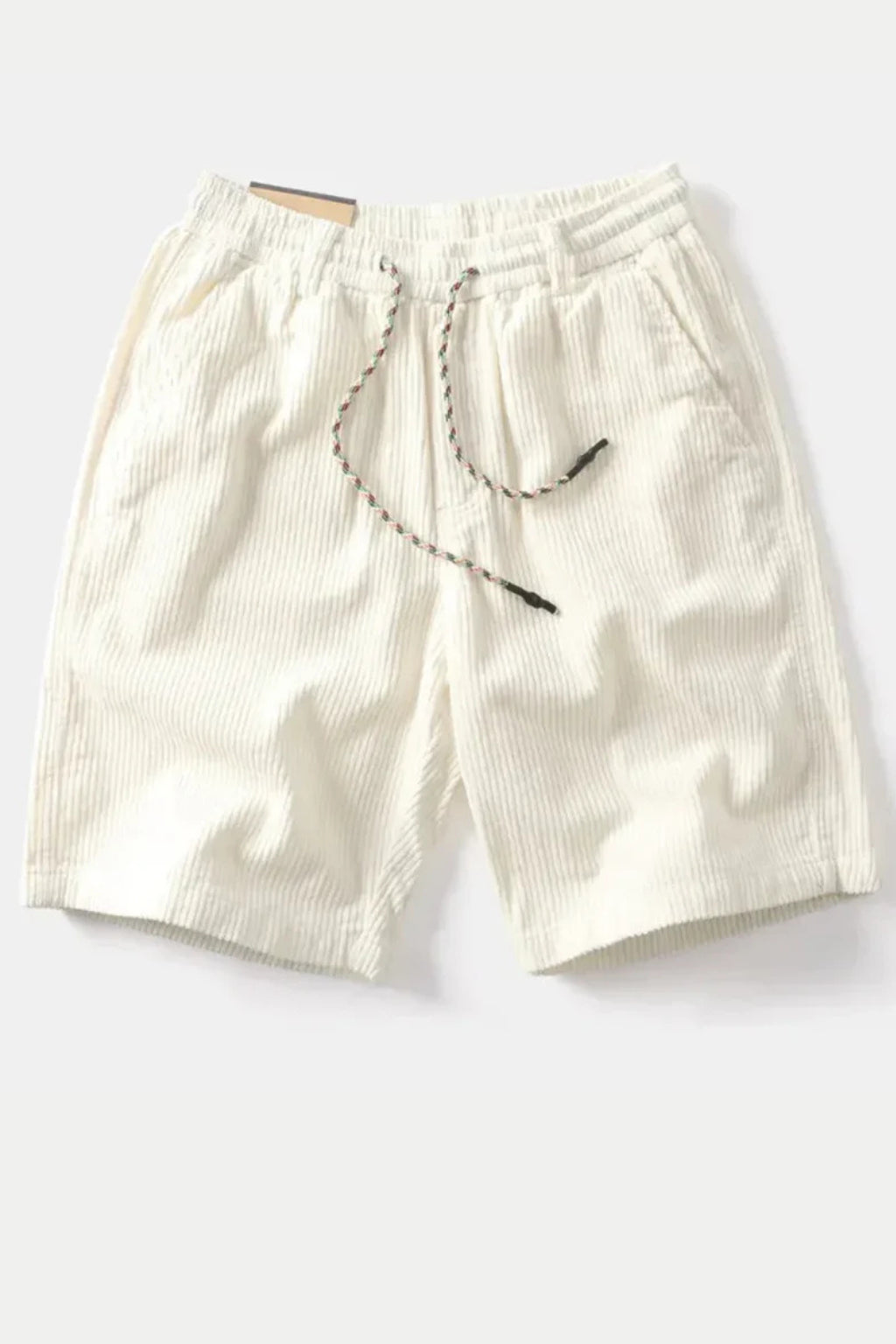 Model seated wearing corduroy shorts