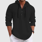 Model wearing hooded shirt, side profile pose