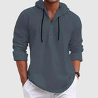 Model wearing hooded shirt with hood up, back view