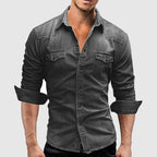 Man wearing light blue denim shirt with jeans, full-length