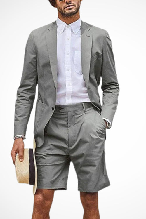 Model wearing grey blazer shorts suit, front-facing pose