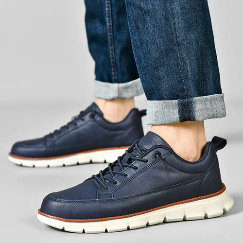 Side profile of leather trainer showing lace-up fastening and silhouette