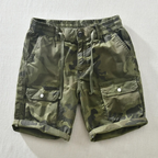 Model wearing camo cargo shorts, standing pose showing fit