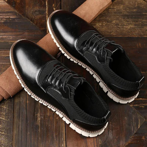 Side profile of tan leather lace-up shoe showing textured panel detail
