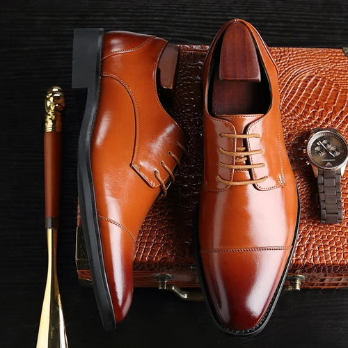 Model wearing black leather oxford shoes with tailored trousers, standing pose