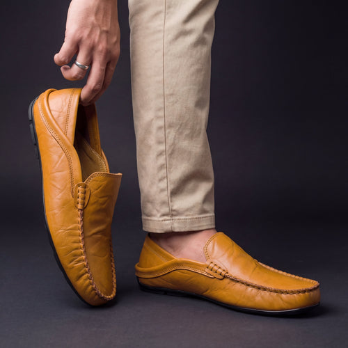 Man wearing leather loafers, standing pose in casual outfit