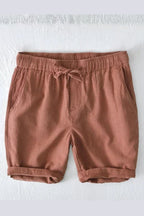 Model wearing linen shorts, standing front-facing pose