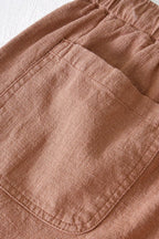 Detail shot of rolled cuff hem on shorts leg