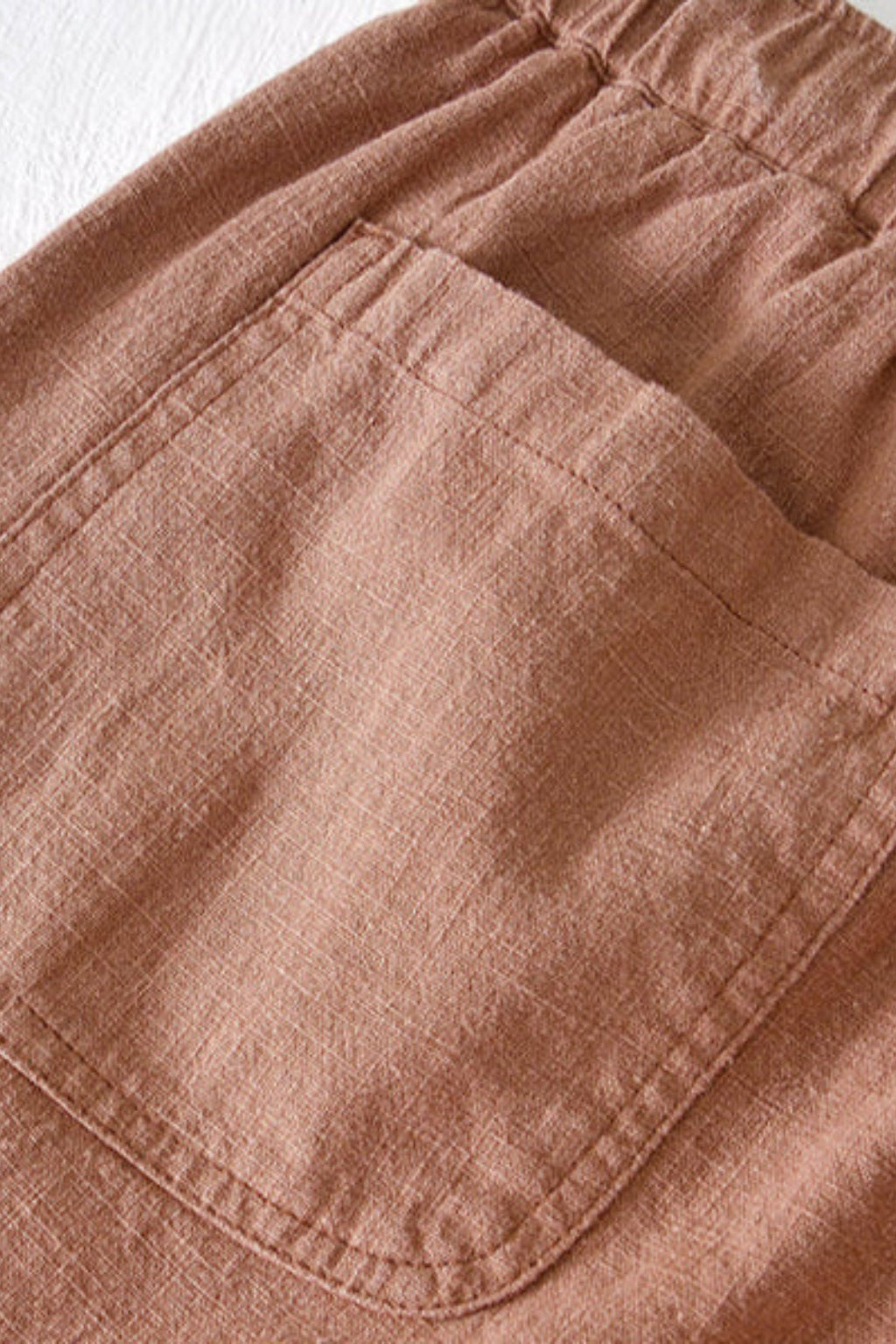 Detail shot of rolled cuff hem on shorts leg