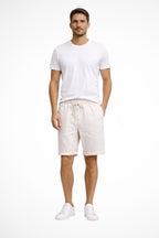 Model wearing linen shorts, side profile view