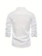 Model wearing white embroidered logo shirt, standing pose