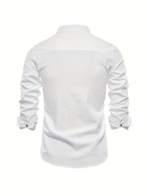 Model wearing white embroidered logo shirt, standing pose