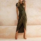 Model wearing navy maxi dress, side profile showing wrap skirt detail