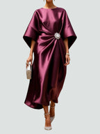 Model wearing navy kimono sleeve dress, standing pose showing draping detail