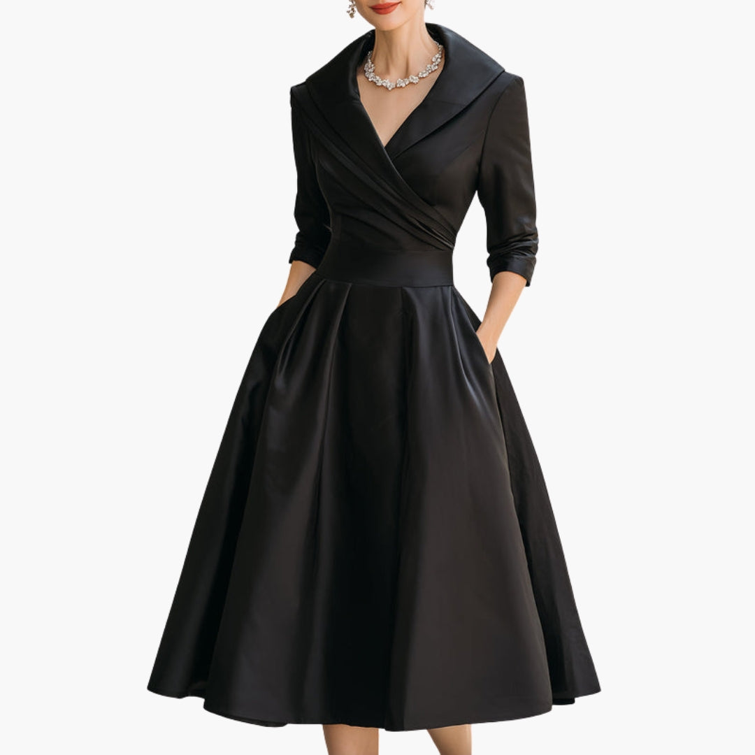 Model in navy wrap dress demonstrating pocket placement and fit