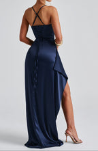 Model wearing navy satin maxi dress, standing pose showing thigh-high split