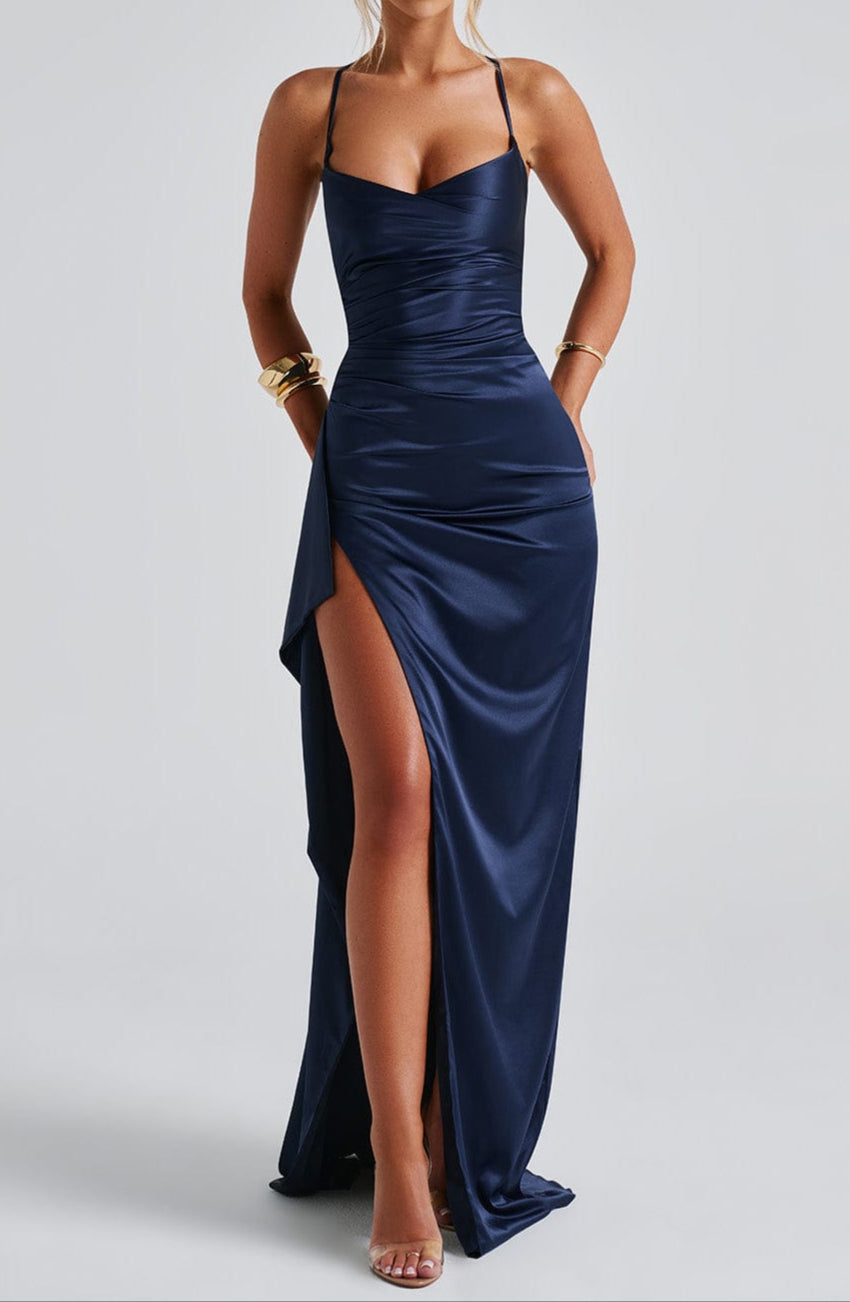 Side profile of model in navy satin maxi dress, highlighting silhouette