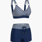 Women's striped halter bikini top and swim shorts set laid flat