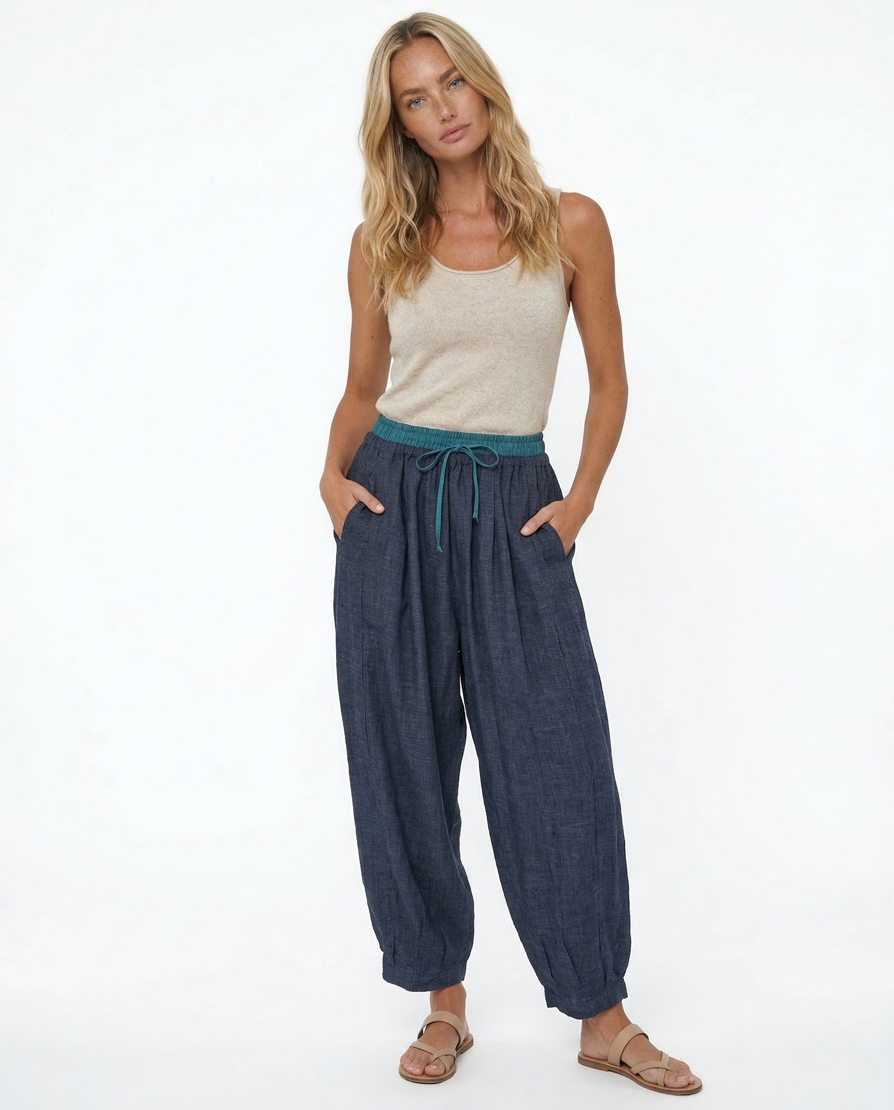 Side detail of peach linen tapered trousers showing pocket opening