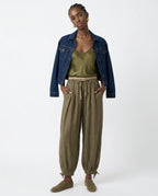 Close-up texture of 100% linen fabric on peach trousers