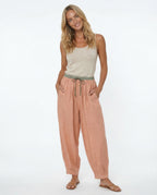 Women's peach linen tapered trousers with sage green drawstring, full length front view