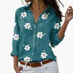 Model in floral shirt from side angle, showing sleeve and cuff detail