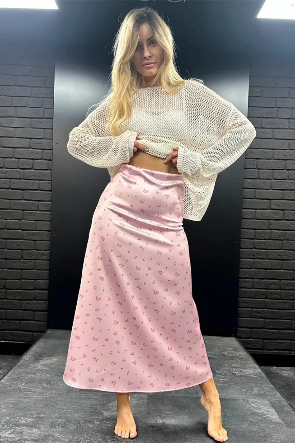Model wearing floral maxi skirt, standing pose showing drape
